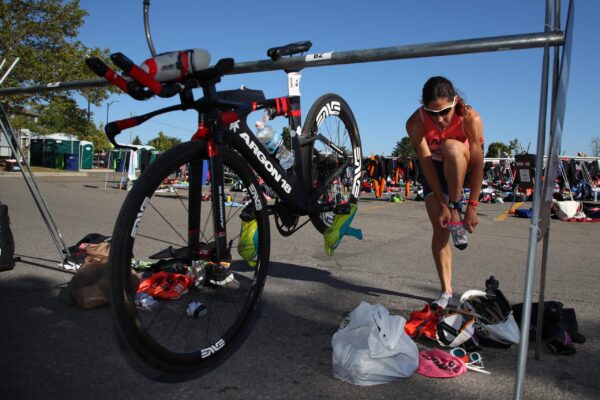 Triathlete transitioning from cycling to running efficiently.